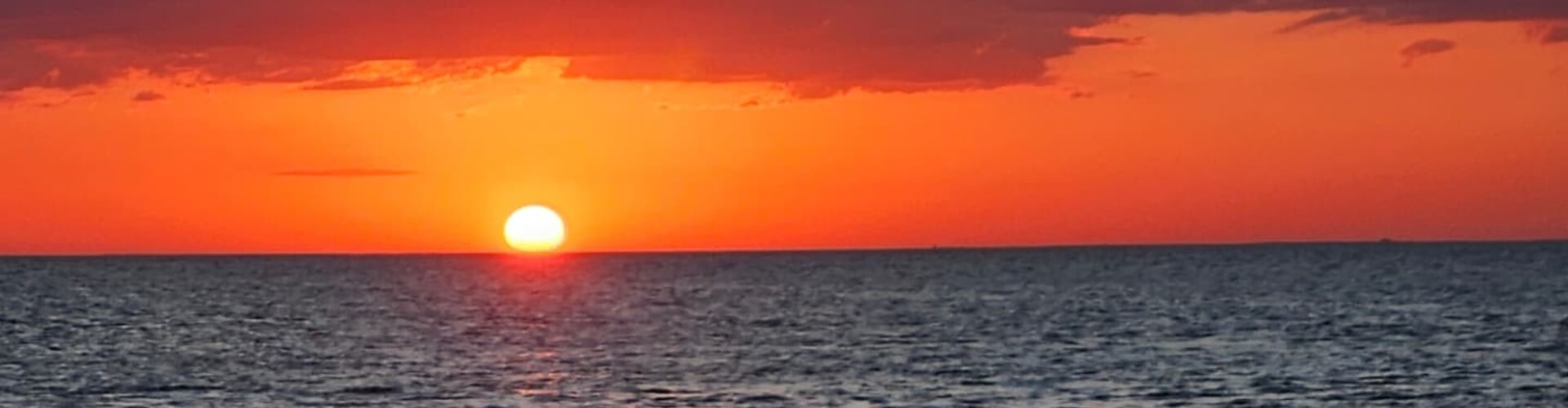 A breathtaking sunset over the water, a perfect scene for Sunset Cruises with Allen's Aquatic Adventures.